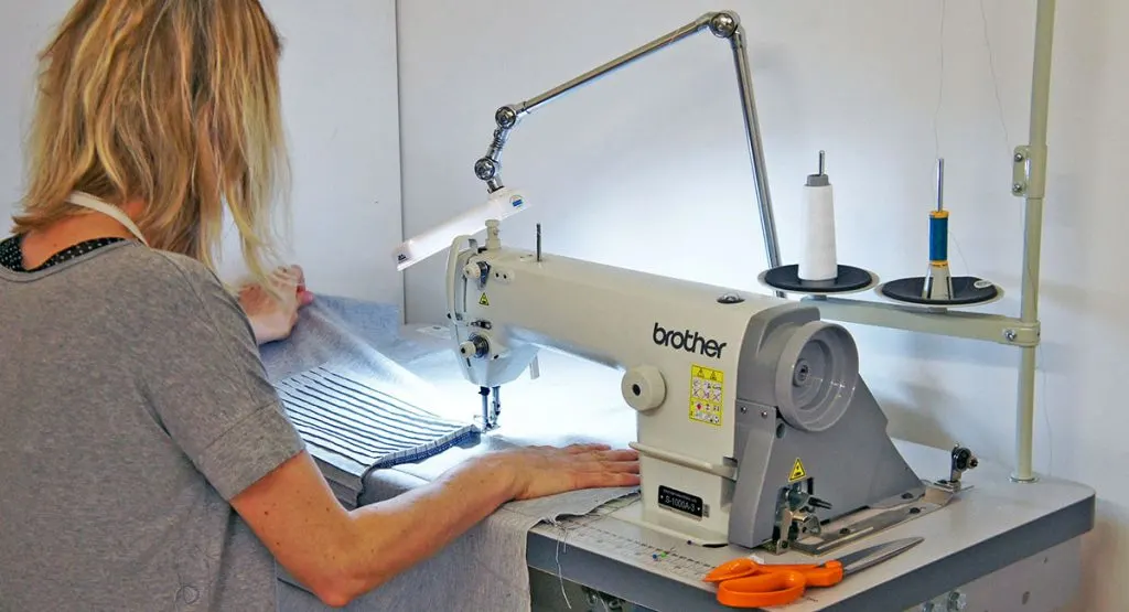 Woman sat at Brother sewing machine sewing a pin tucked pocket
