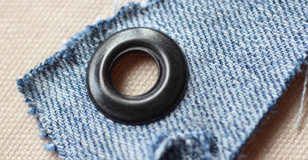 The upper part of an inserted eyelet or grommet - how to put eyelets into fabric. 