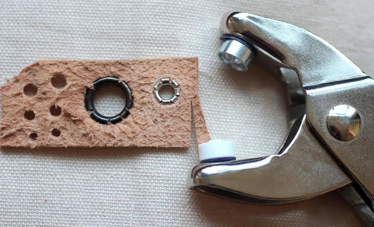 Putting eyelets in using a hammer