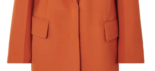 Close up photo of an orange jacket, highlighting a type of inset pocket
