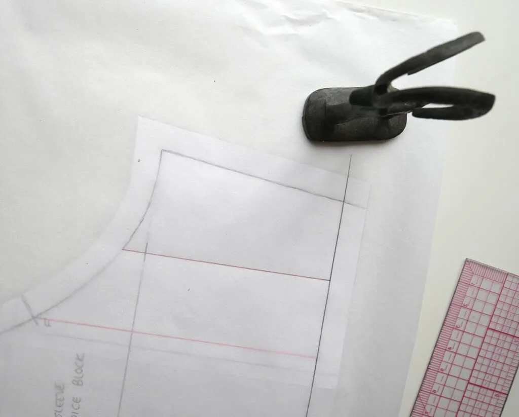 The first section of a short sleeve is traced to become part of a puff sleeve pattern.