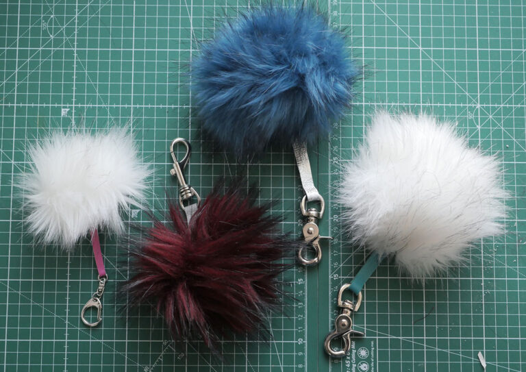 Selection of four faux fur plush pom pom keychains