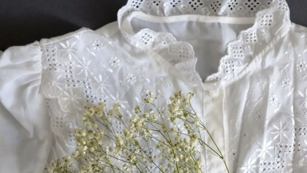 Details of a white eyelet blouse