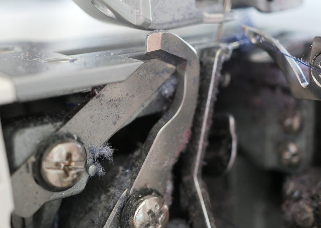 Close up photo of the blade on a serger sewing machine