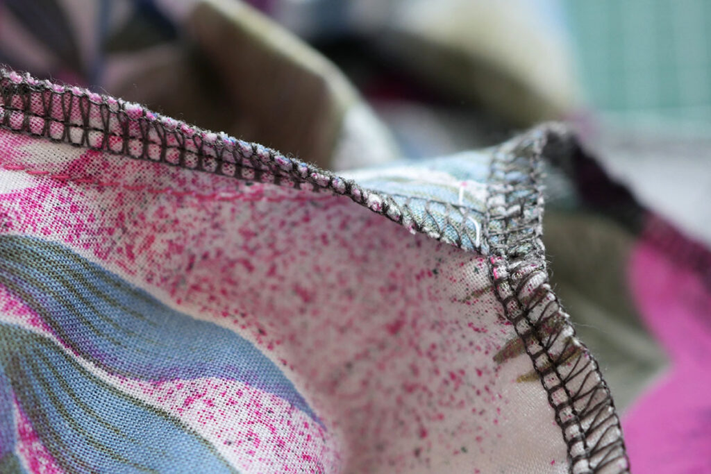 Close up photo of the stitching using a four thread serge on woven fabric