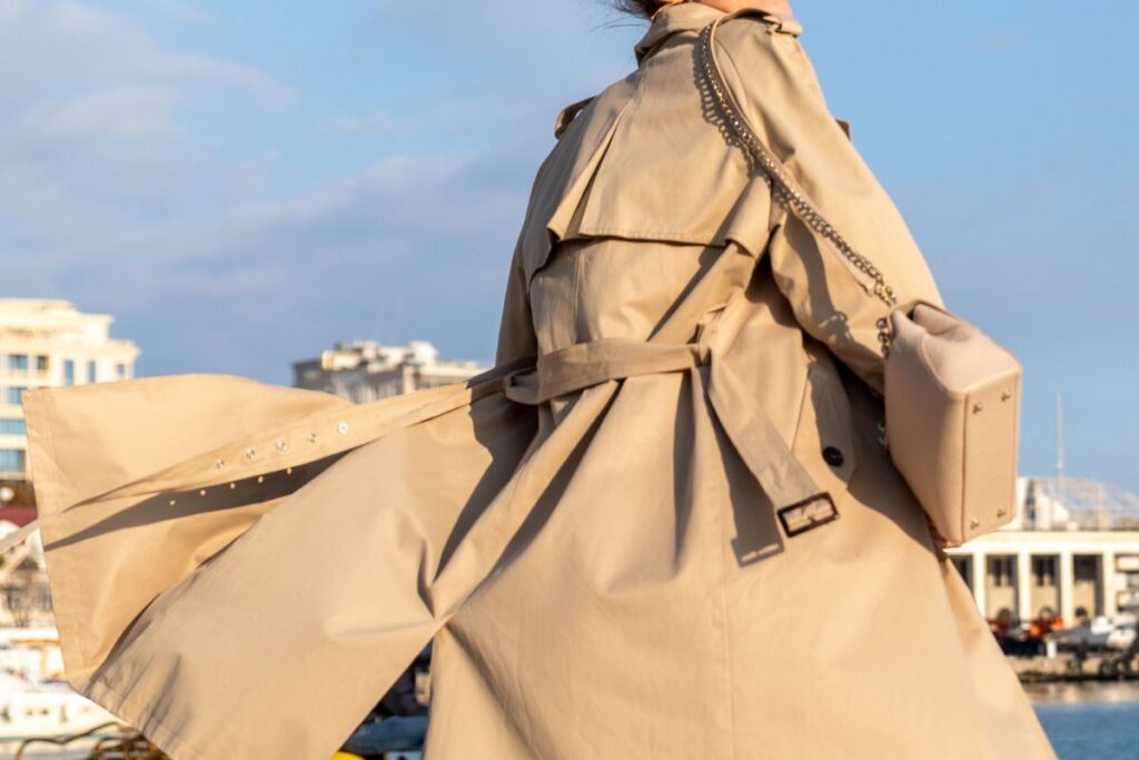 Back view of a trench coat with a storm flap