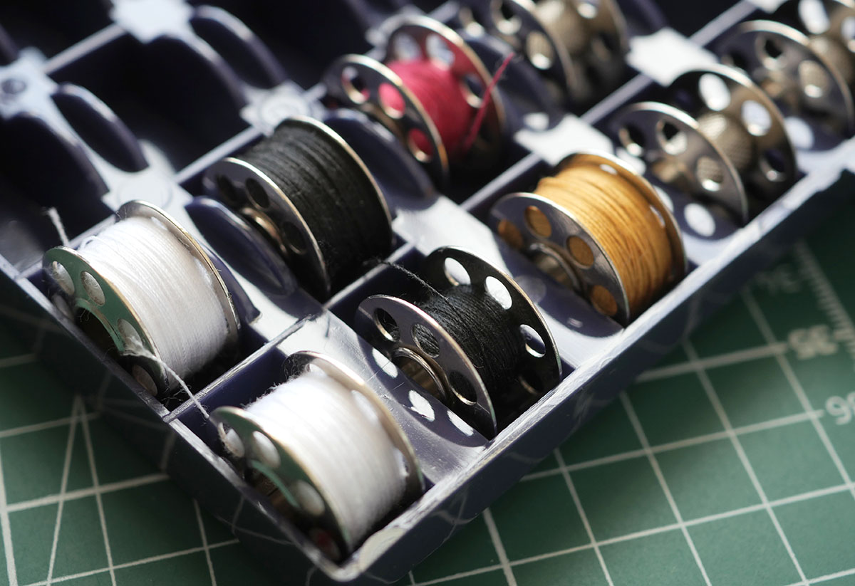 Selection of sewing machine bobbins full of thread