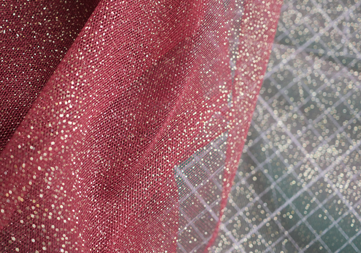 Red stretch tulle fabric with gold glitter detail