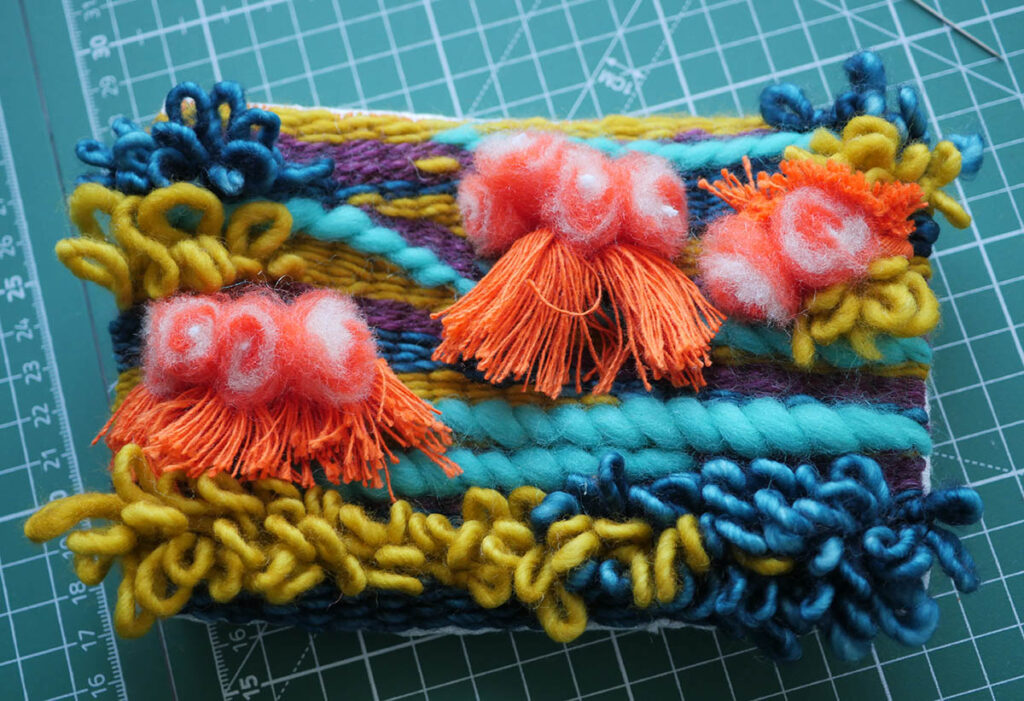 The completed zippered puch with weaving applique