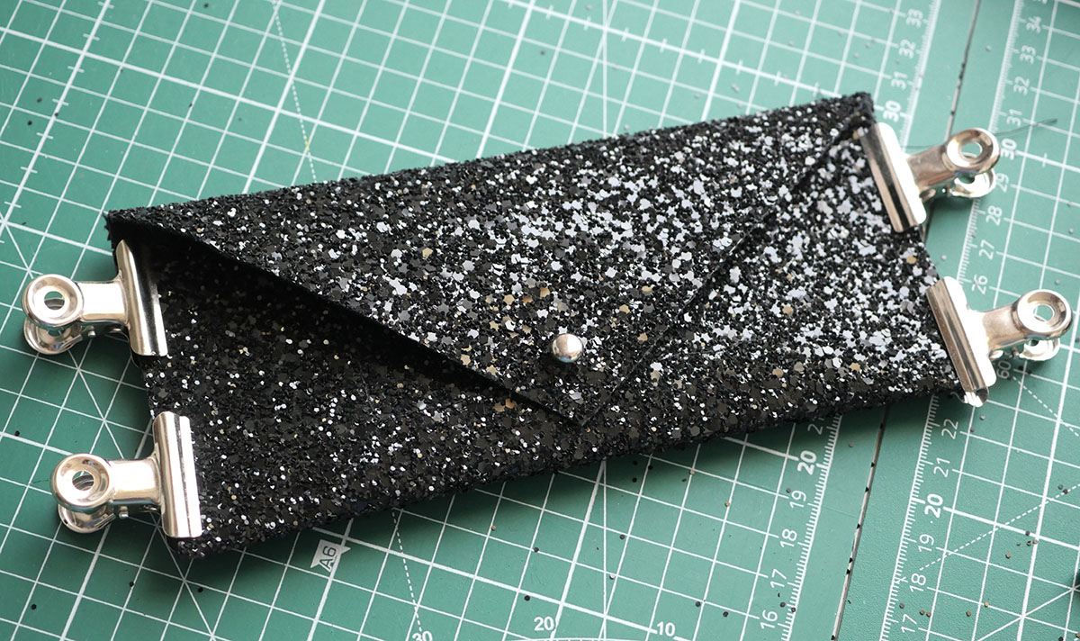 Next step is to secure the shorter ends of the wallet - I used clips to temporarily hold the encrusted denim in place before sewing them closed