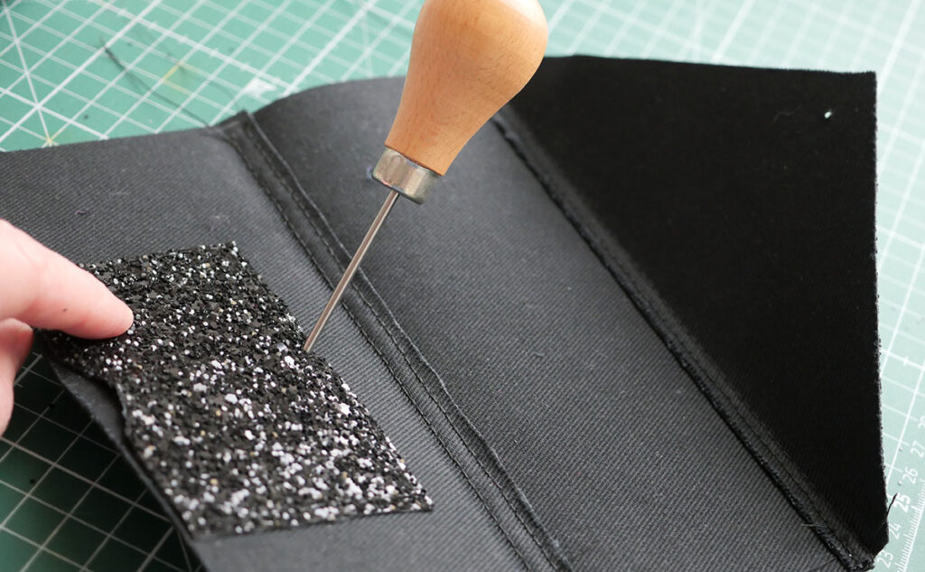 Use the awl to mark in the location of the fastening (assuming this step was not done earlier on in the construction process)