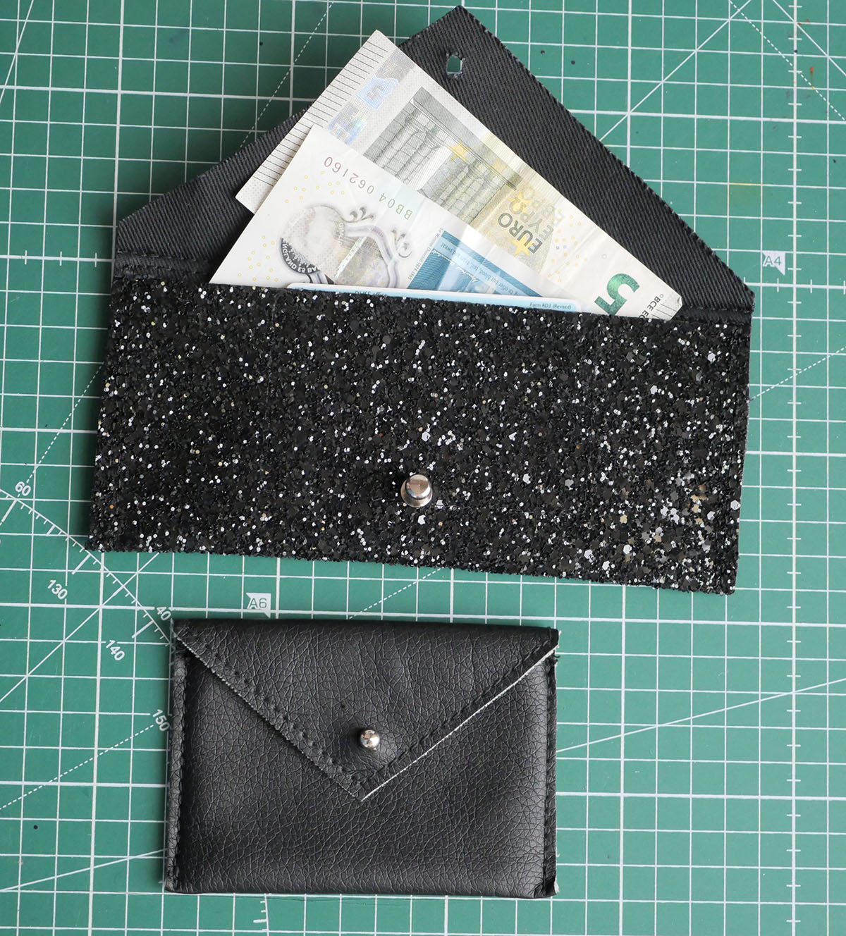 The larger wallet made in this tutorial alongside the smaller version made in a. previous tutorial