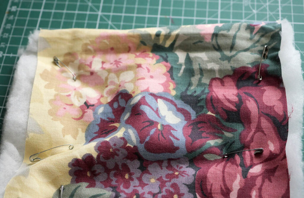 Holding the quilt pieces together with safety pins