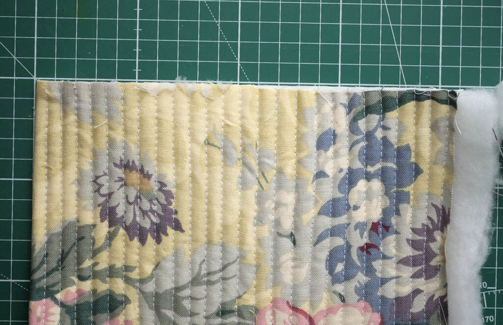 Tidy the quilt panel by trimming the edges with a rotary cutter