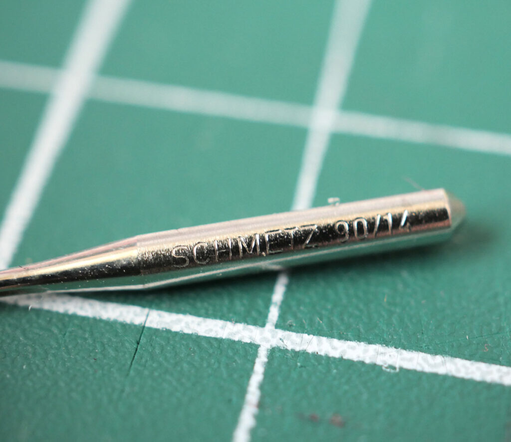 Finding the size on a sewing machine needle is tricky as it is engraved in very small letters