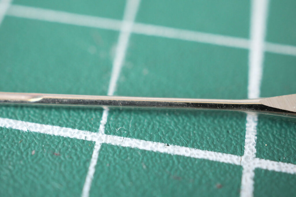 The blade on a sewing machine needle is the long part of the needle from the shoulder down to the tip.