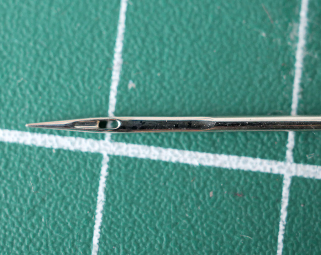 The short groove on a sewing machine needle is a much shorter groove found on the opposite side of the sewing machine needle.