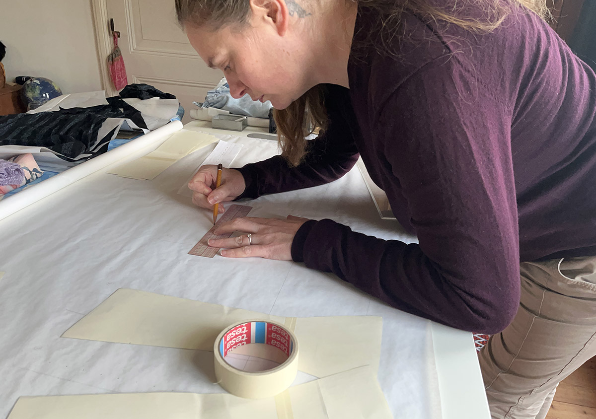 Eve working on the pattern for her denim corset
