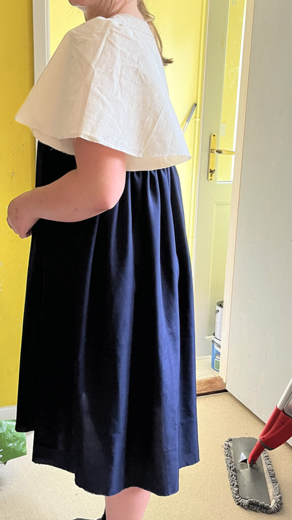 Side view of Sophie in her bridesmaid dress toile