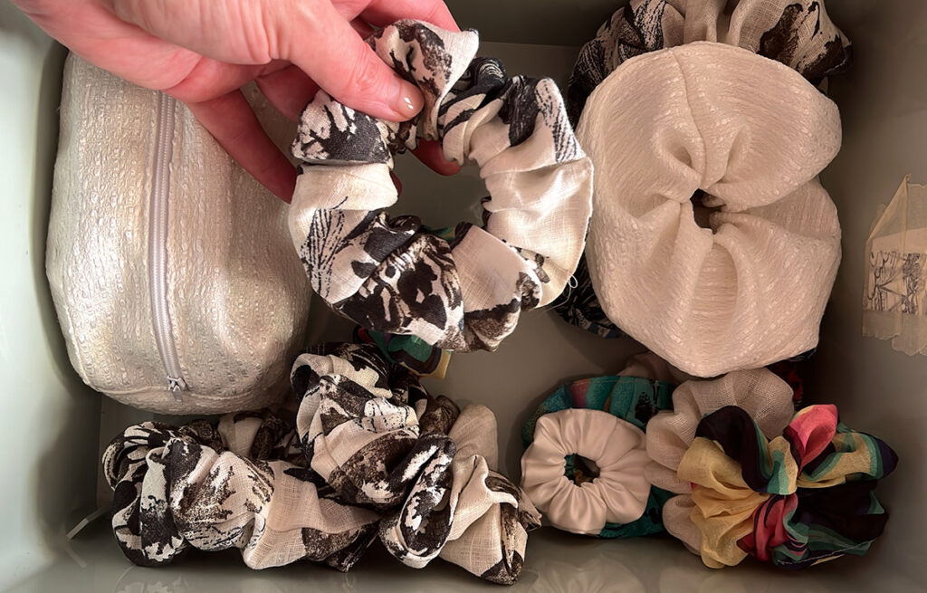 A bucket full of handmade scrunchies using the burrito method