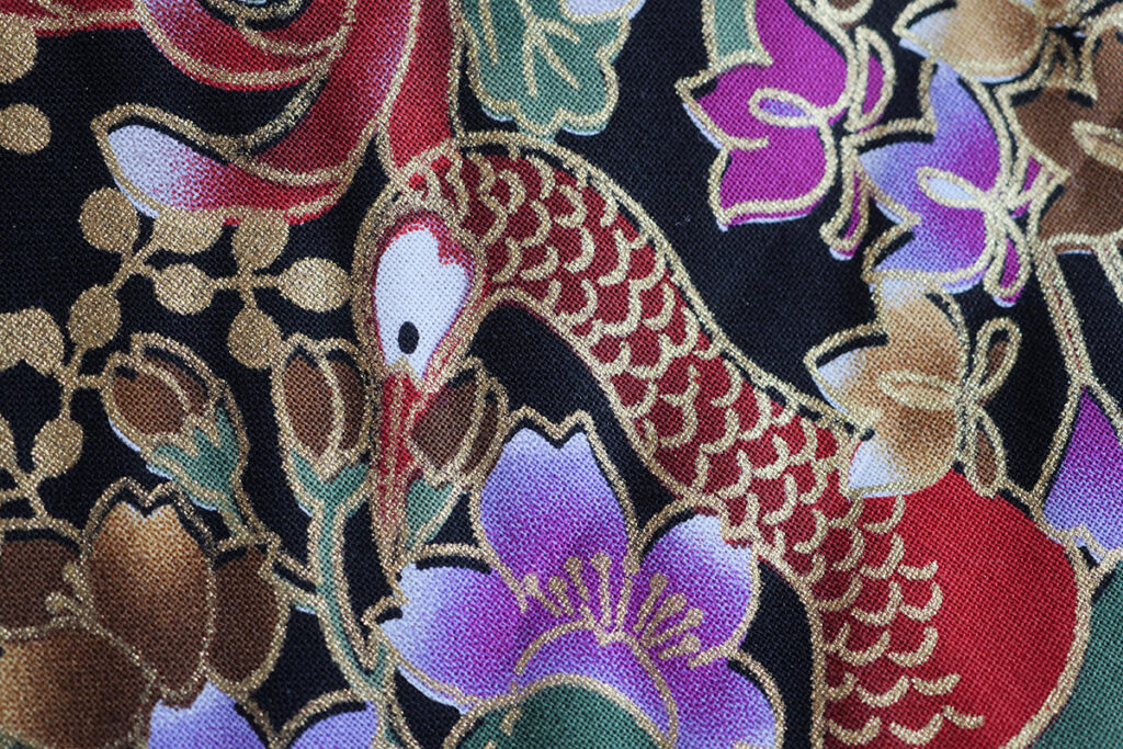 A woven cotton with printed peacocks close up detail