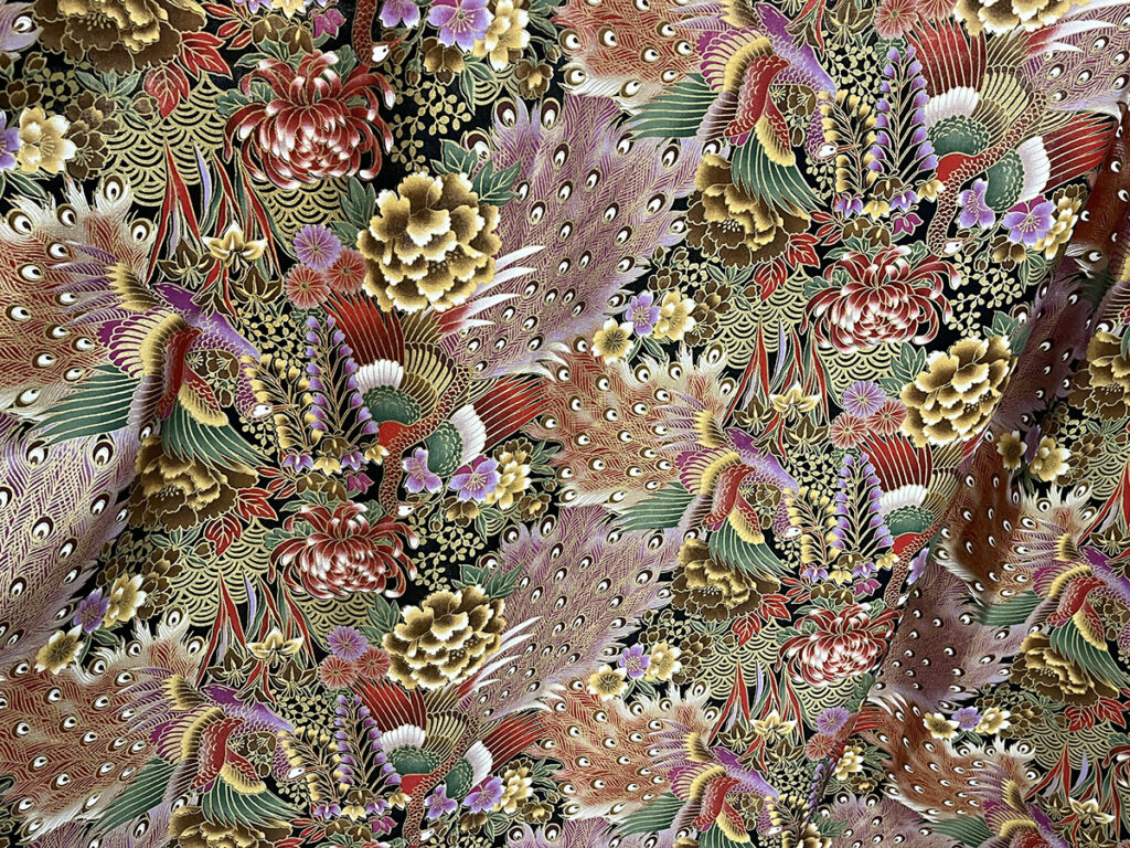 A woven cotton with printed peacocks on full repeat